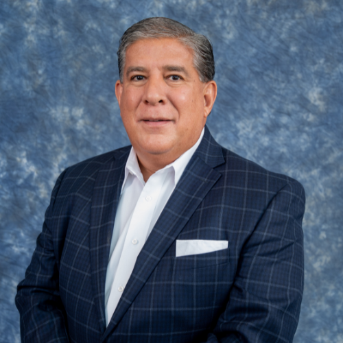 John Hernandez, senior vice president of amegy bank, smiles while wearing a suit