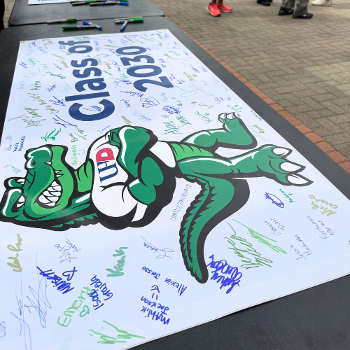 A Class of 2030 signed banner with names of incoming students from Houston area high schools who have commited to the University of Houston-Downtown for fall 2026