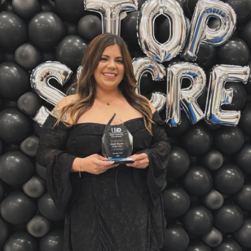 Natalie Salinas holds an award at the university's One Main Event.