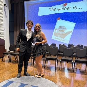 A student award-winner in a cocktail dress holds an award next to a student presenter at the university of houston-downtown's student life and involvement's student awards ceremony