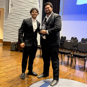 A student award winner stands aside a fellow university of houston-downtown student at the university's annual student award ceremony