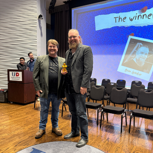 A O'Kane Theatre staff member stands with a student award-winner