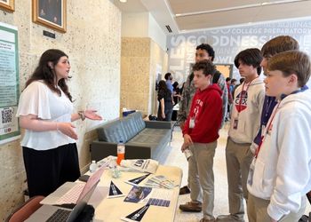 A group of high school students listen to a University of Houston-Downtown student's presentation on chemistry and the effect of street drugs on the body