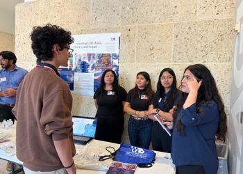 high school students at st thomas high school listen to organic chemistry students presentations