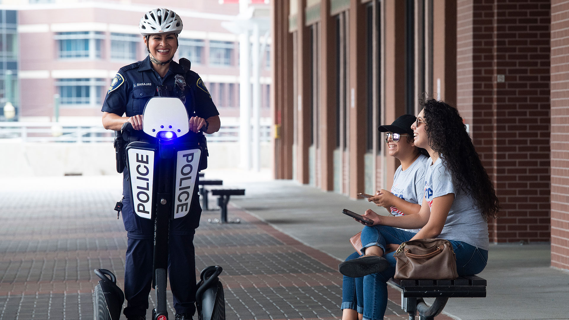 Police Officer on Segway with Students on Bench
