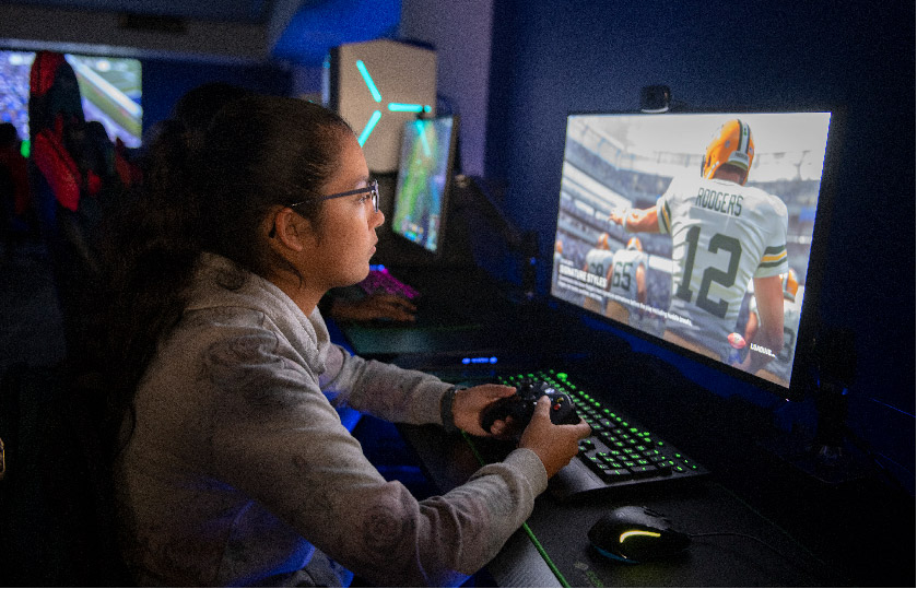 uhd student playing video game in the eSports center