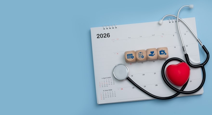 Stethoscope and foam shaped hear laying on top of calendar.