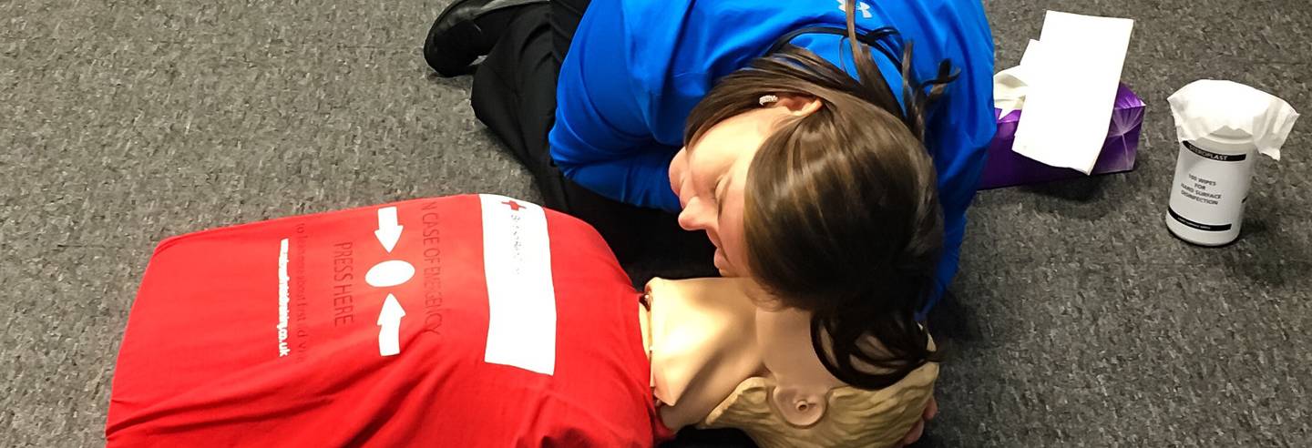 first aid cpr classroom training on a mannequin dummy