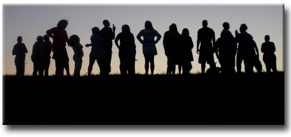 Silhouettes of Students standing in grass