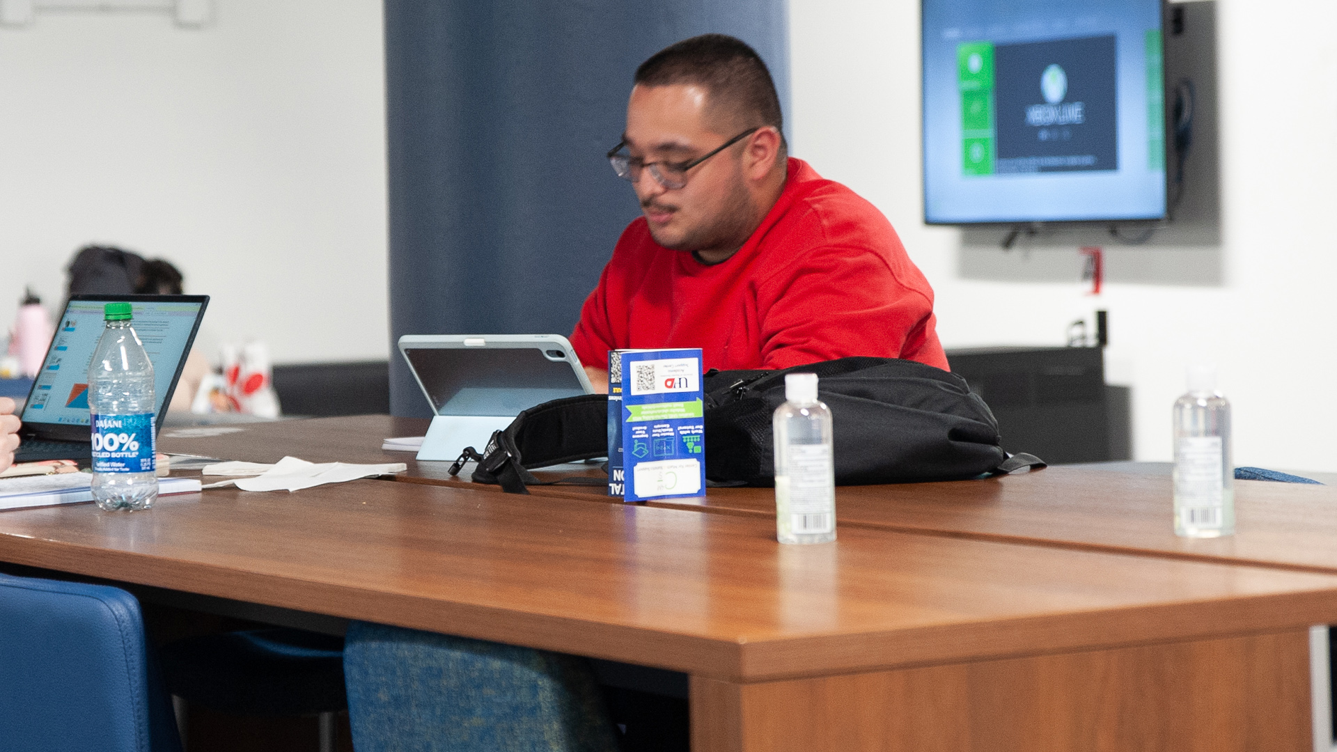 UHD student on laptop in student lounge