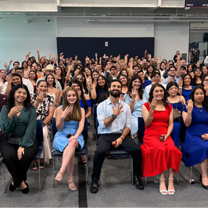 UHD students and alum hold up UHD class rings at the university's ring ceremony