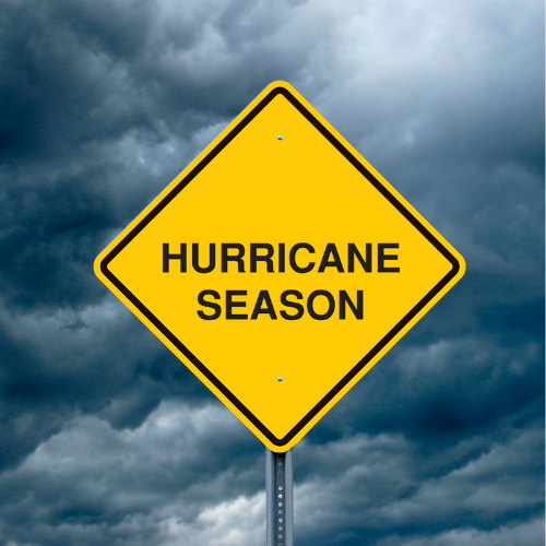 Stormy sky with clouds and a road sign that reads, "Hurricane Season"