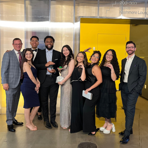 Marilyn Davies College of Business Dean Jonathan Davis, Ph.D., and UHD staff, alumni, students, and faculty smile holding an American Marketing Association Houston Crystal Award at the AMA Crystal Awards Gala at 713 Music Hall in Houston, Texas