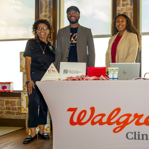 Vanessa Mattox, Student and member of university of houston downtown's black student association, smiles aside a walgreens clinical trials representatives at a community baby shower for new and expectant parents in the university community at the university of houston downtown