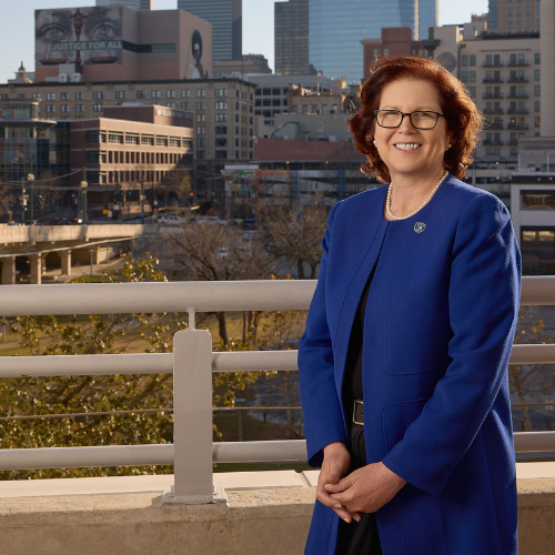 Deborah Bordelon smiles while wearing a University of Houston Downtown pin and blue blazer. Bordelon is Provost and Senior Vice President for Academic Affairs at University of Houston Downtown. 