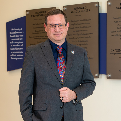 Jonathan Davis wears a blazer and smiles in the Marilyn Davies College of Business at the University of Houston-Downtown. Davis will serve at the university's Provost starting May 1, 2026.