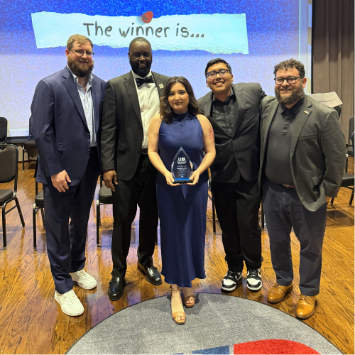 Student success and student life staff and student leadership and involvement staff stand with a student holding an award at the university of houston-downtown's one main event awards ceremony.