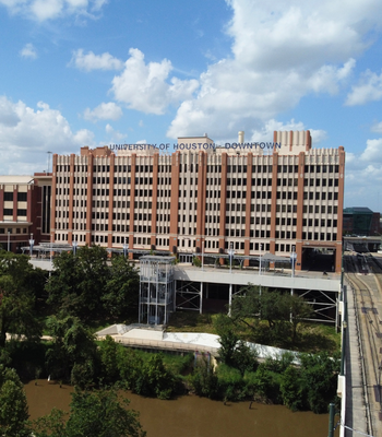 The University of Houston-Downtown's One Main Building, the bayou, and a bridge in Downtown Houston