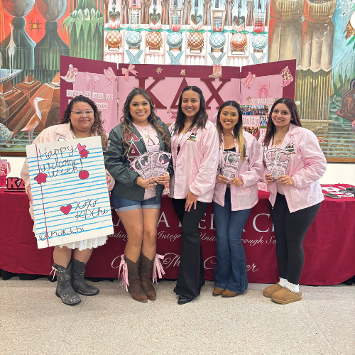 University of Houston-Downtown's Kappa Delta Chi student chapter holds a sign and tables on the university's third floor mural area during week of welcome.
