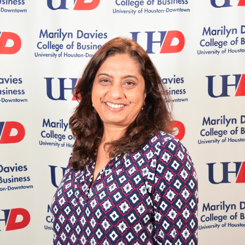 Arpita Shroff smiles in front of a marilyn davies college of business step-and-repeat at the university of houston-downtown. Shroff spearsheaded the volunteer income tax assistance program at the university of houston-downtown. 