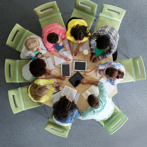Nine adults sit at a round table during a focus group