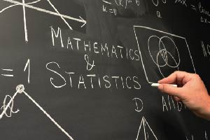 Two students in labcoat looking at a sample