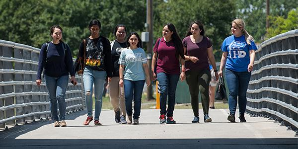 Students walking together across a bridge
